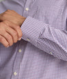 Model is wearing UNTUCKit Alvarado shirt in small plum and maroon check. 