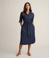 Model is wearing UNTUCKit Denim Popover Amanda Shirtdress in blue. 