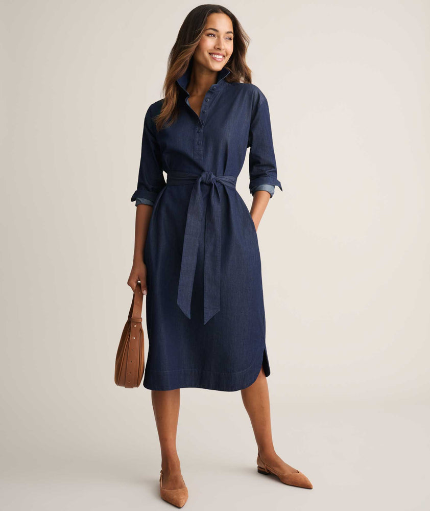 Model is wearing UNTUCKit Denim Popover Amanda Shirtdress in blue. 