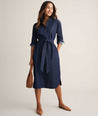 Model is wearing UNTUCKit Denim Popover Amanda Shirtdress in blue. 