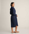 Model is wearing UNTUCKit Denim Popover Amanda Shirtdress in blue. 