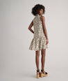 Model is wearing UNTUCKit Amara dress in floral tan print.