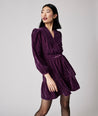 Model is wearing UNTUCKit Amy dress in solid purple.