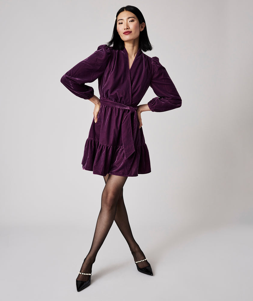 Model is wearing UNTUCKit Amy dress in solid purple.