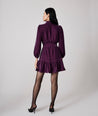 Model is wearing UNTUCKit Amy dress in solid purple.