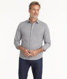 Model is wearing UNTUKit Wrinkle-Free Performance Apremont Shirt in Gray Grounded Maroon Check.