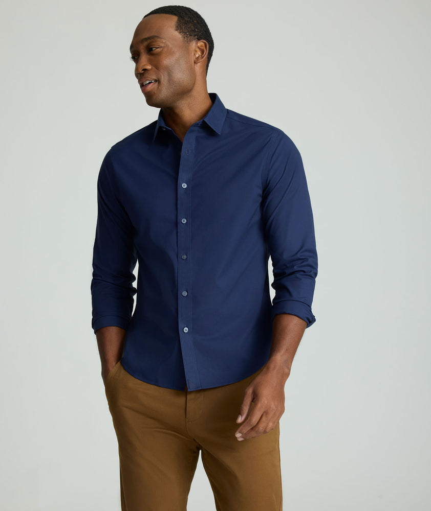 Model is wearing UNTUCKit Arden wrinkle-free shirt in navy.