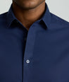 Model is wearing UNTUCKit Arden wrinkle-free shirt in navy.