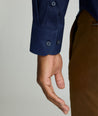 Model is wearing UNTUCKit Arden wrinkle-free shirt in navy.