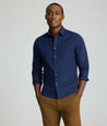 Model is wearing UNTUCKit Arden wrinkle-free shirt in navy.