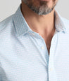 Model is wearing UNTUCKit Performance Short-Sleeve Arundel Shirt in Light Blue Crab Print.