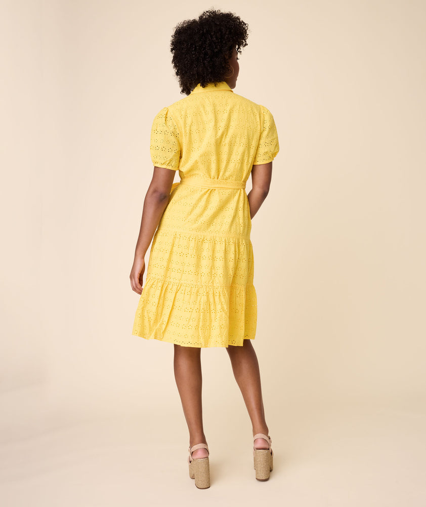 Model is wearing UNTUCKit solid Yellow Augusta Dress.