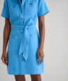 Model is wearing UNTUCKit avry dress in solid blue. 