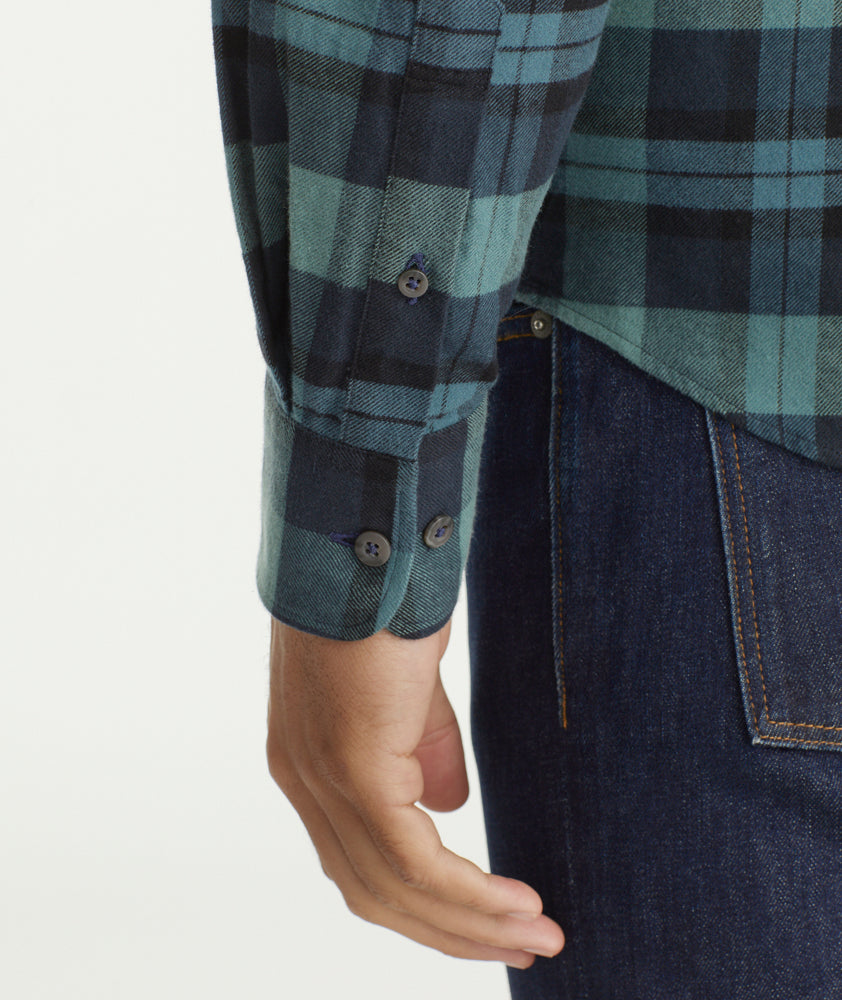 Model is wearing UNTUCKit Flannel Azedo Shirt in Teal & Navy Plaid.