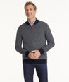 Model is wearing UNTUCKit Birdseye Merino Wool Quarter-Zip Sweater in Heather Navy.