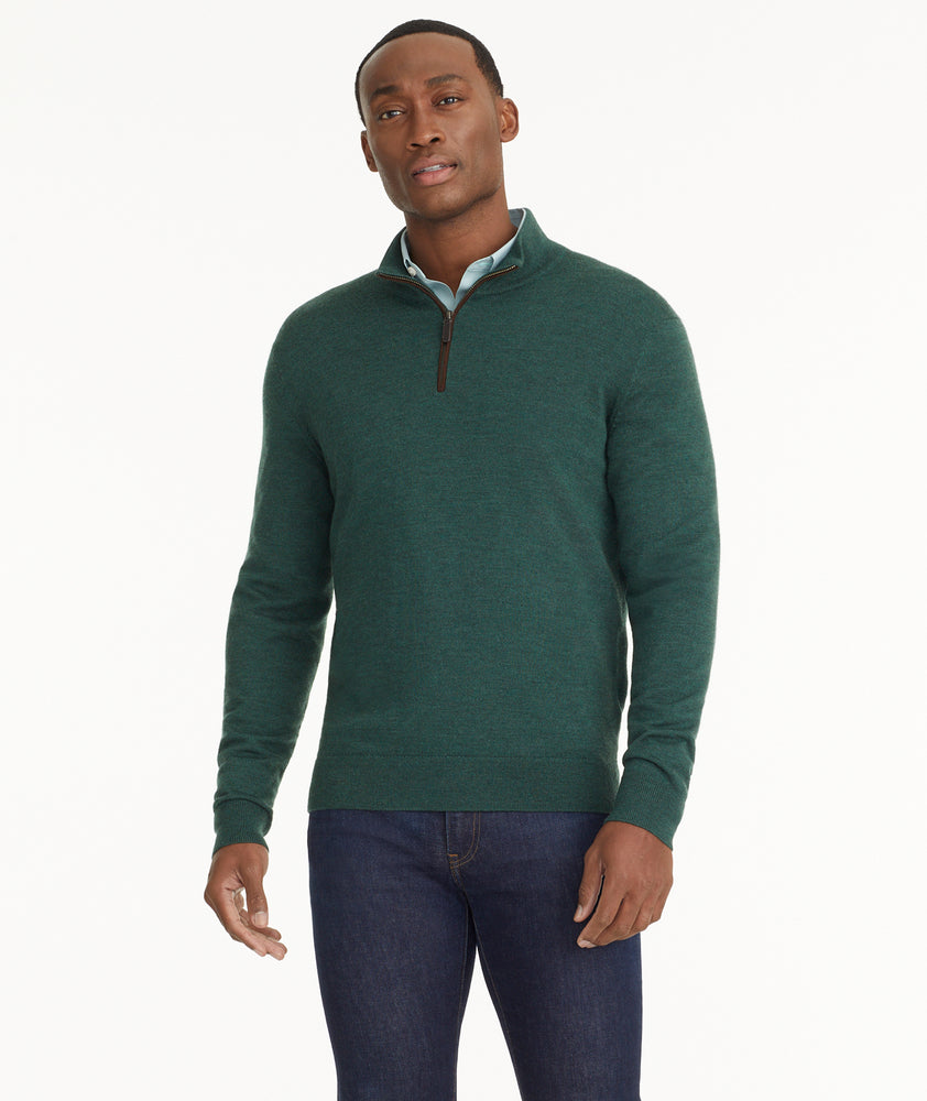 Model is wearing UNTUCKit Merino Wool Quarter-Zip Sweater in Heathered Green With Suede Placket.
