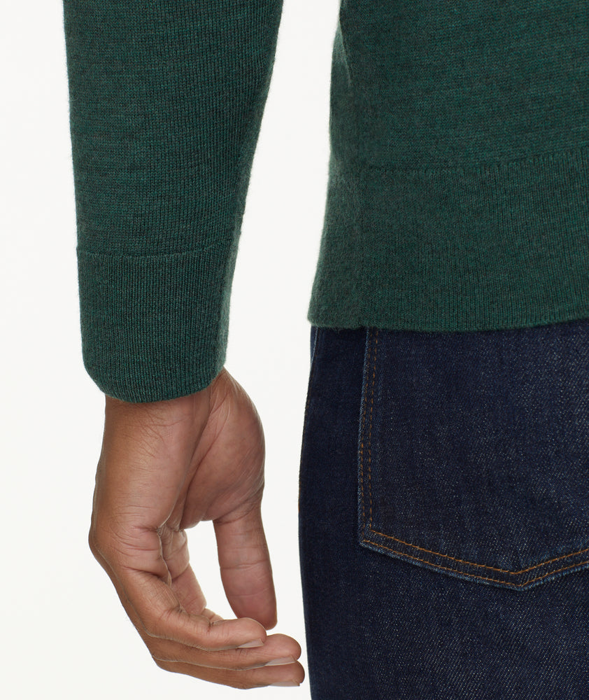 Model is wearing UNTUCKit Merino Wool Quarter-Zip Sweater in Heathered Green With Suede Placket.