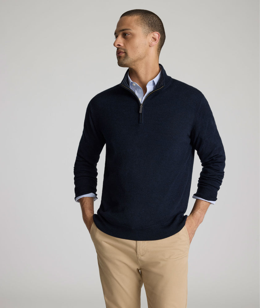 Model is weraring UNTUCKit Belguardo quarter zip in navy.