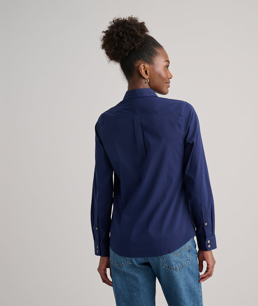 Model is wearing UNTUCKit Bella shirt in navy.