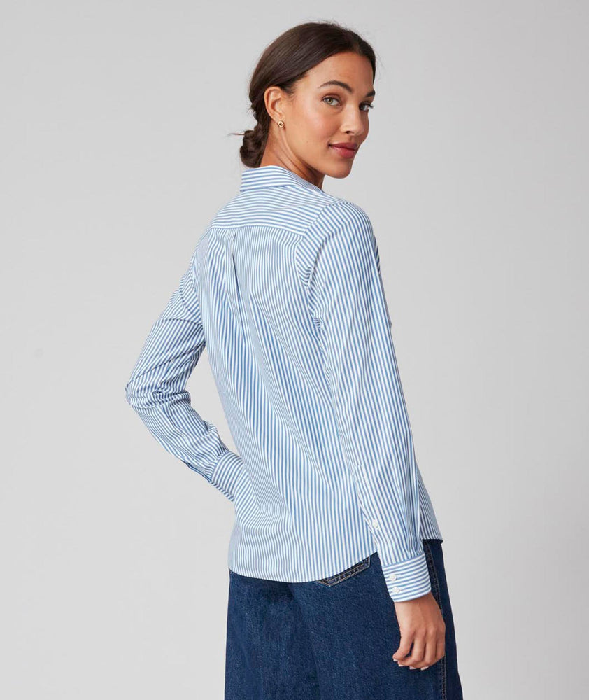 Model is wearing the UNTUCKit Bella Shirt in Blue Stripe. 