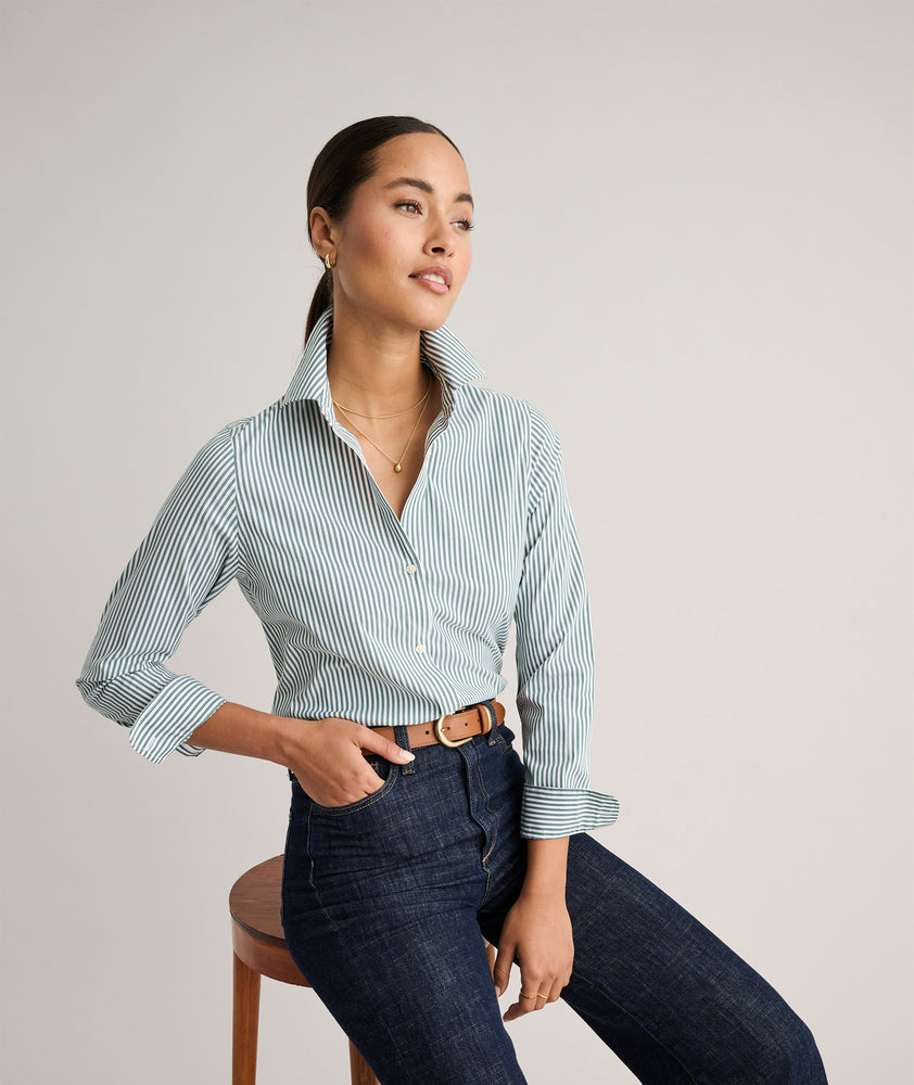 Model is wearing UNTUCKit Wrinkle- Free Cotton Stretch Bella Shirt in green and white strip. 