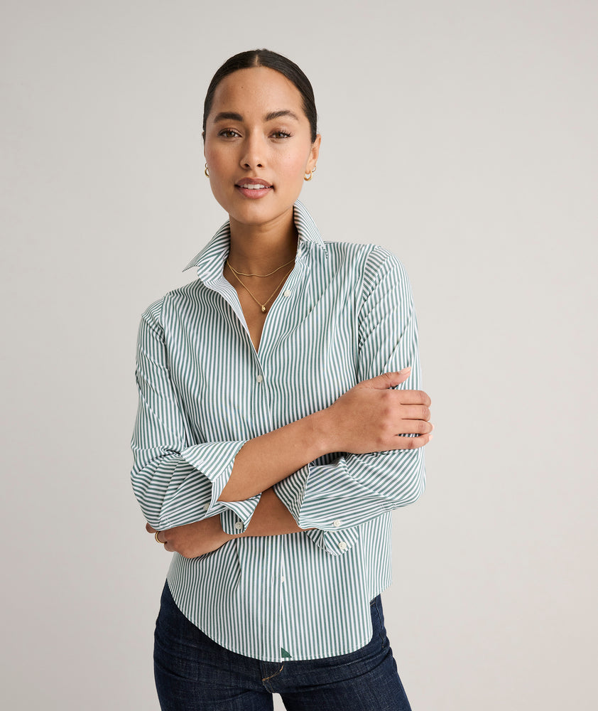 Model is wearing UNTUCKit Wrinkle- Free Cotton Stretch Bella Shirt in green and white strip. 