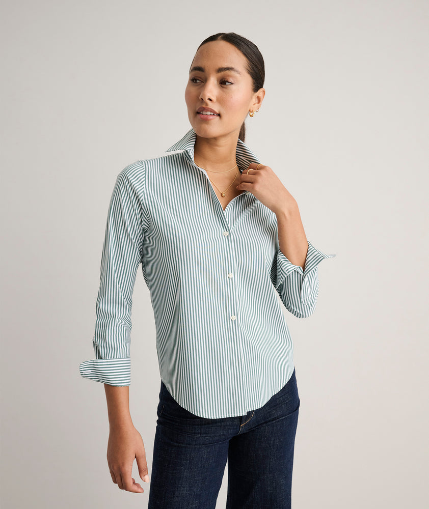 Model is wearing UNTUCKit Wrinkle- Free Cotton Stretch Bella Shirt in green and white strip. 