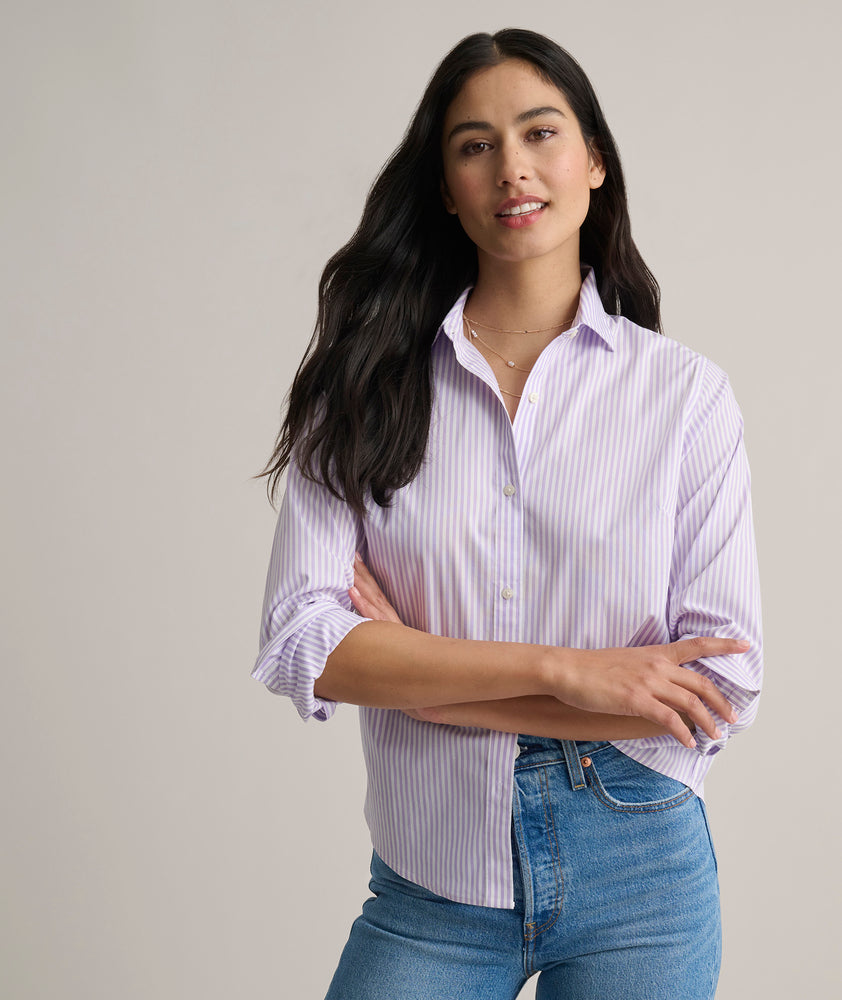 Model is wearing UNTUCKit Bella shirt in purple stripe. 