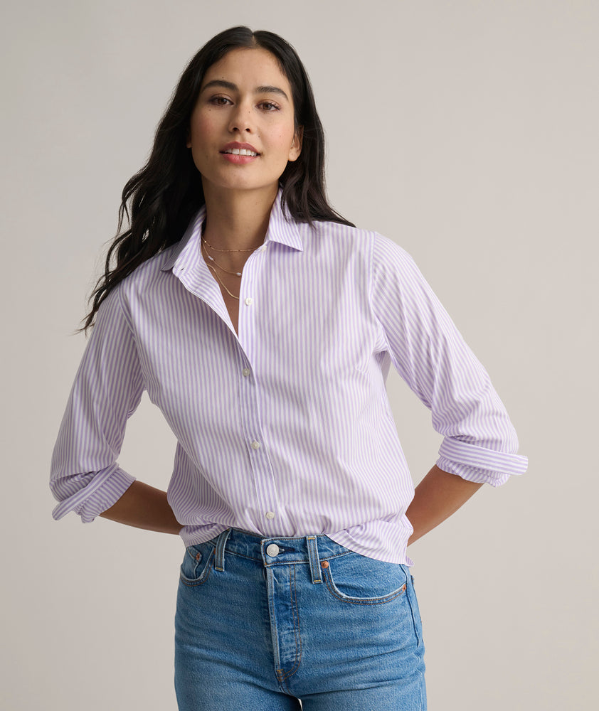 Model is wearing UNTUCKit Bella shirt in purple stripe. 
