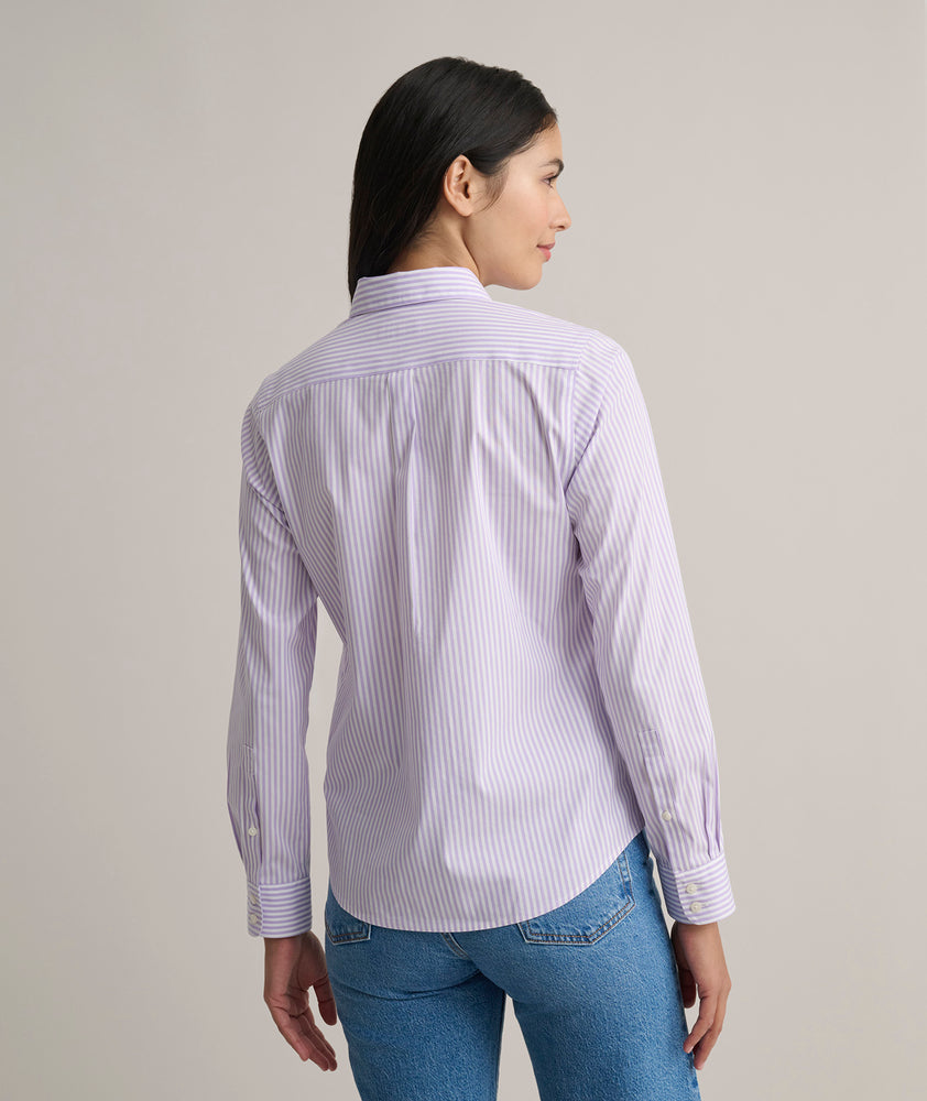 Model is wearing UNTUCKit Bella shirt in purple stripe. 