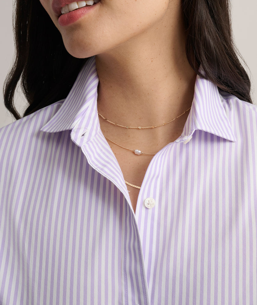 Model is wearing UNTUCKit Bella shirt in purple stripe. 