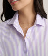 Model is wearing UNTUCKit Bella shirt in purple stripe. 