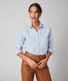 Model is wearing UNTUCKit Bella shirt in light blue multi stripe.