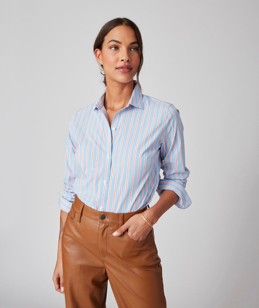 Model is wearing UNTUCKit Bella shirt in light blue multi stripe.