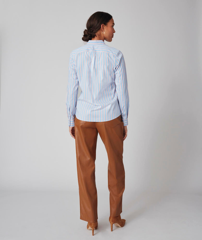 Model is wearing UNTUCKit Bella shirt in light blue multi stripe.