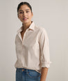Model is wearing UNTUCKit Bella shirt in tan. 