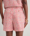 Model is wearing UNTUCKit Ada short in red. 