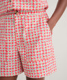 Model is wearing UNTUCKit Ada short in red. 
