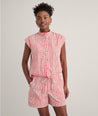 Model is wearing UNTUCKit Ada short in red. 