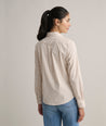 Model is wearing UNTUCKit Bella shirt in tan. 