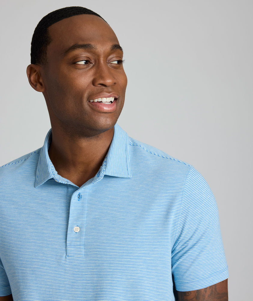 Model is wearing UNTUCKit Belvoir polo on blue aqua