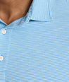 Model is wearing UNTUCKit Belvoir polo on blue aqua.