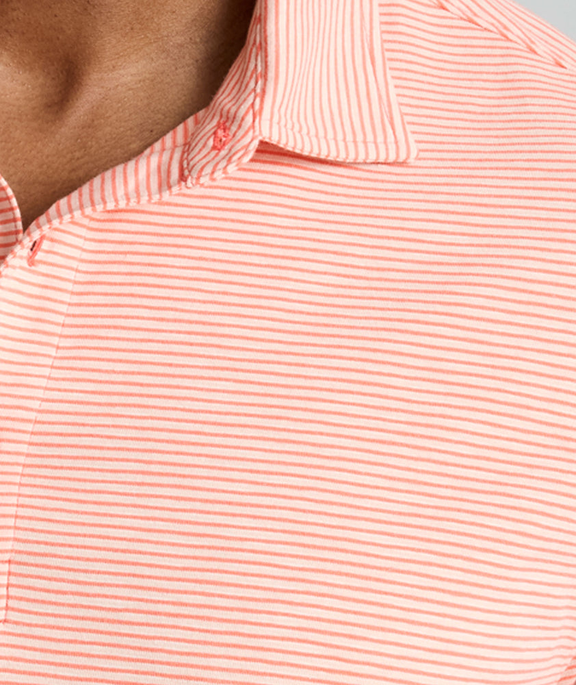 Model is wearing UNTUCKit Belvoir polo in emberglow. 