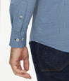 Model is wearing UNTUCKit Wrinkle-Free Performance Benny Shirt in Navy Grounded Gold & White Dot Print.