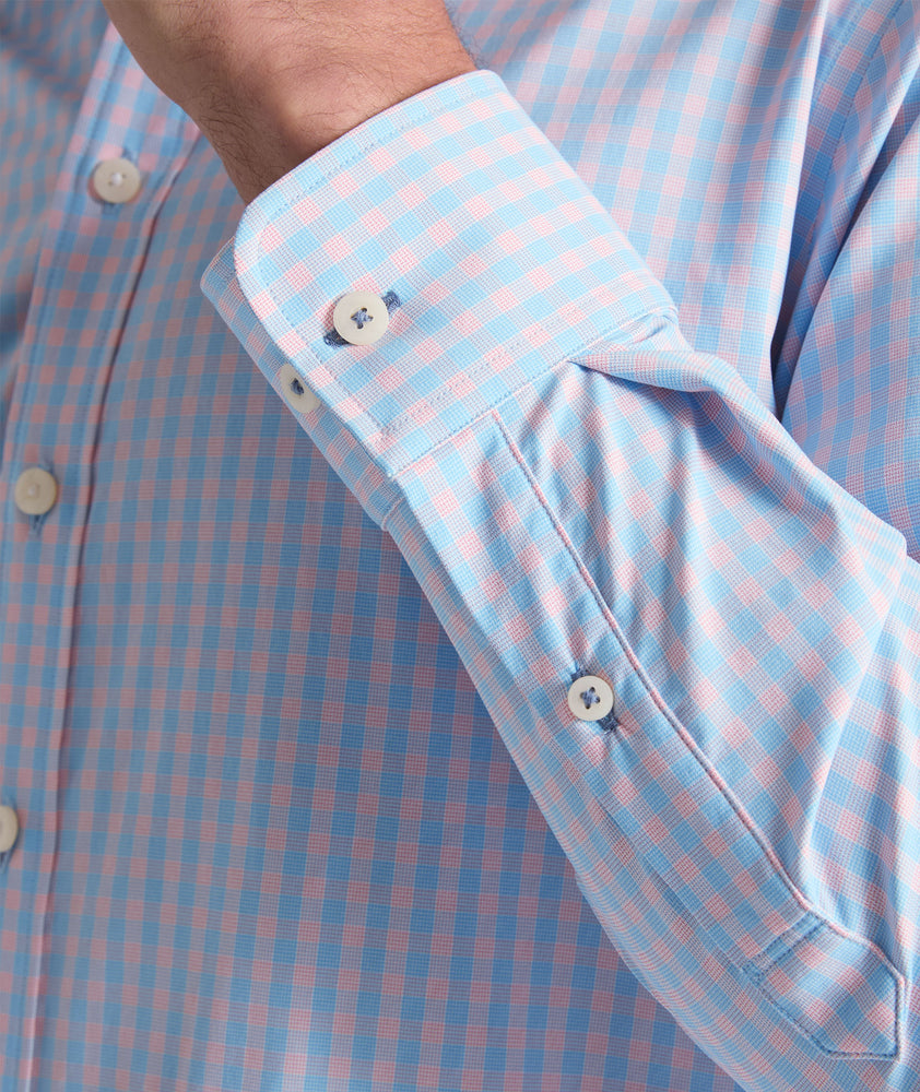 Model is wearing UNTUCKit Benson shirt in pink and blue gingham. 