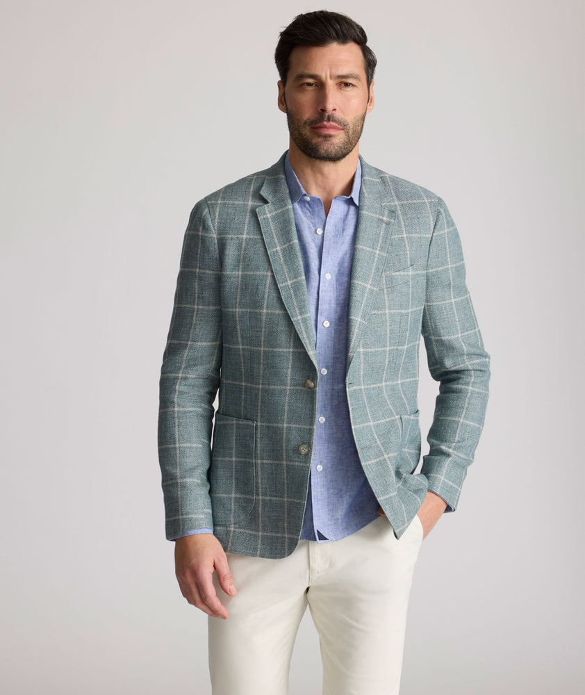 Model is wearing UNTUCKit Bartrand sport coat in windowpane green. 