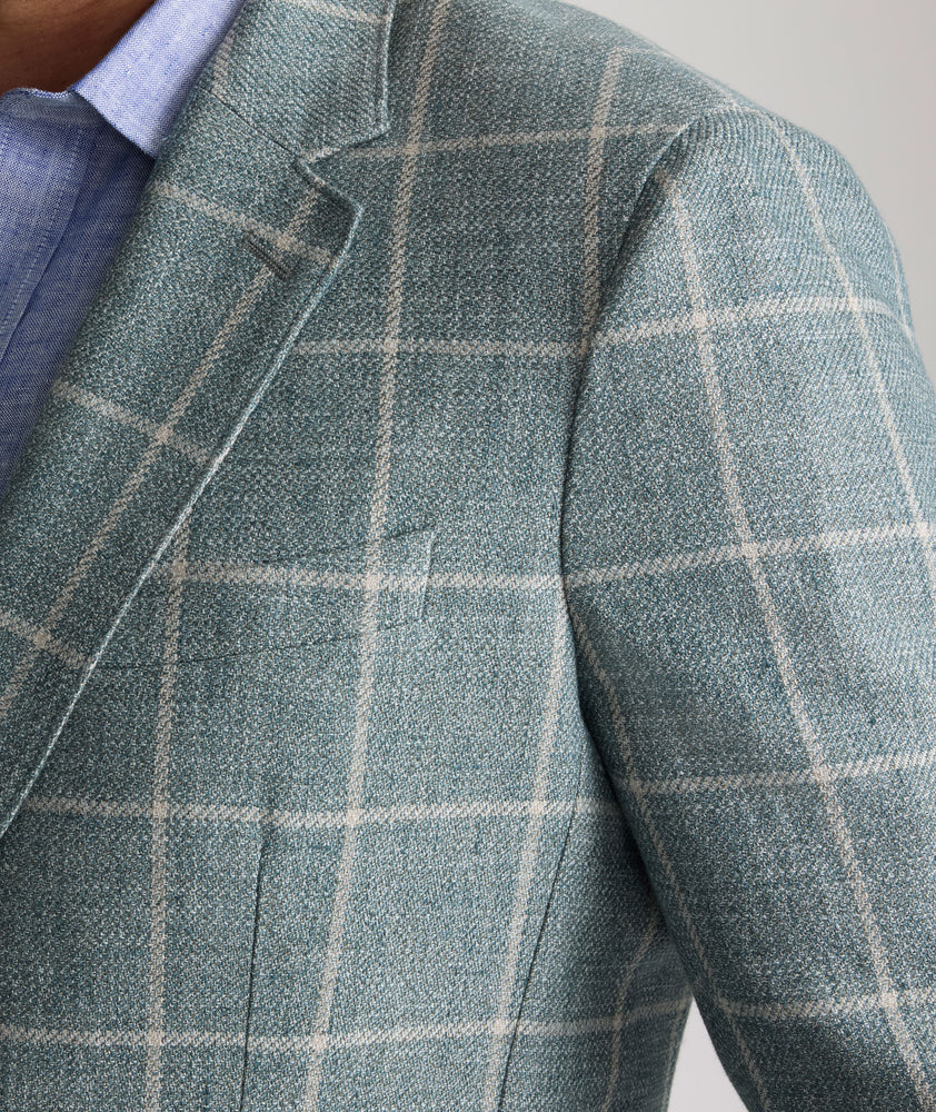 Model is wearing UNTUCKit Bartrand sport coat in windowpane green. 