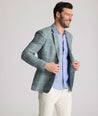 Model is wearing UNTUCKit Bartrand sport coat in windowpane green. 
