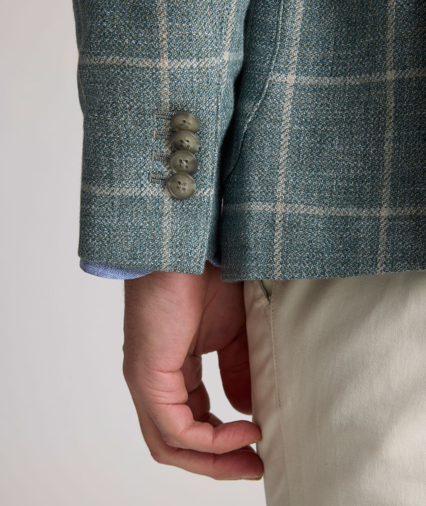 Model is wearing UNTUCKit Bartrand sport coat in windowpane green. 