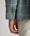 Model is wearing UNTUCKit Bartrand sport coat in windowpane green. 